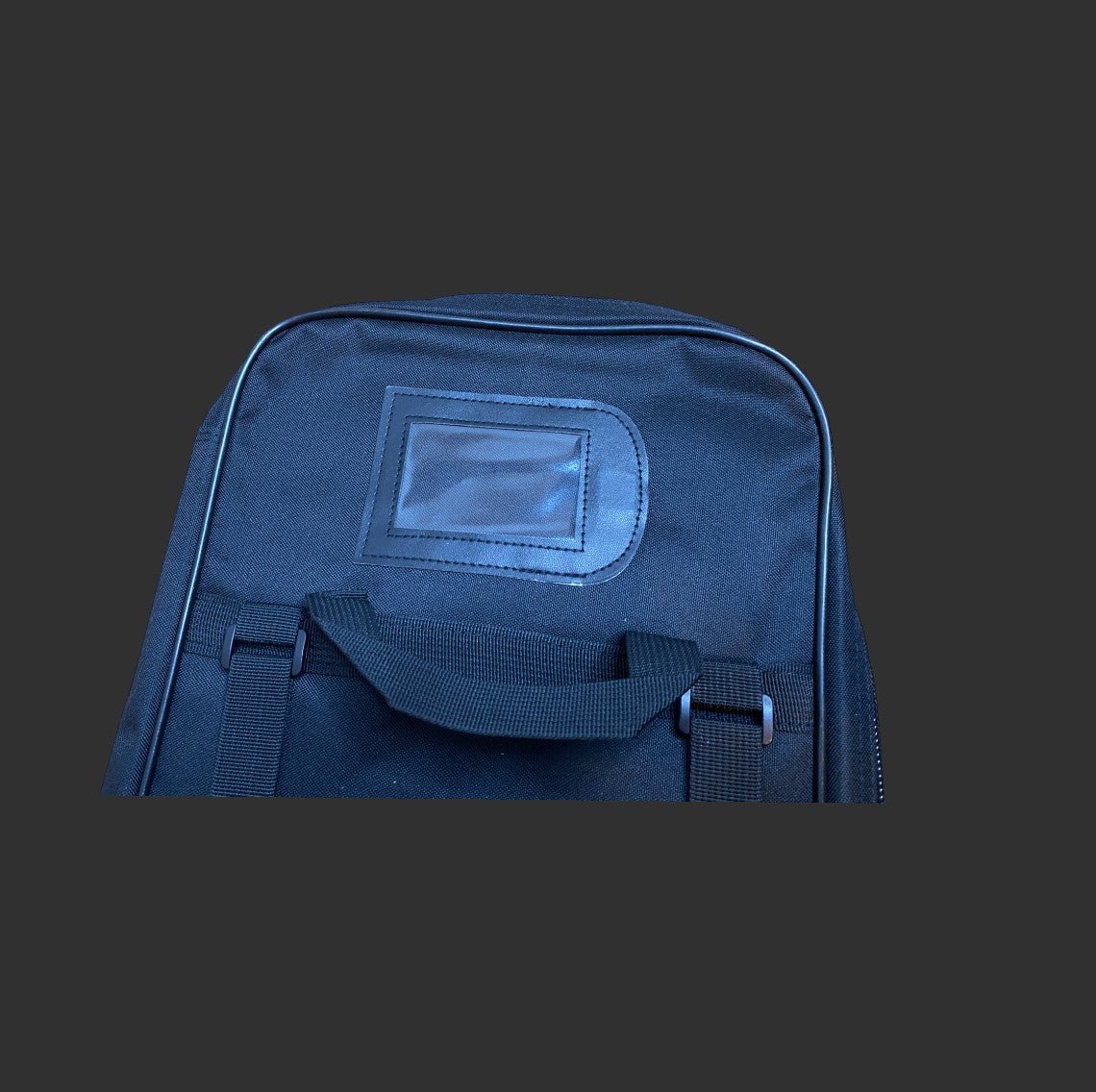 A black BM 36'' dual gun backpack made from water-resistant 600D nylon, featuring a top handle and a small rectangular window on the front. The background is a plain dark color.