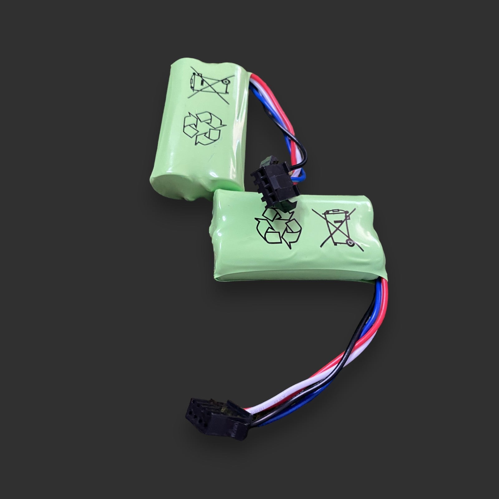 Two Twin XQ Li-ion 7.4v 14500/ 500 mAh 2S battery packs with attached wires and connectors are displayed on a dark background. The 7.4V 14500 Li-ion batteries feature recycling and disposal symbols on their surfaces.