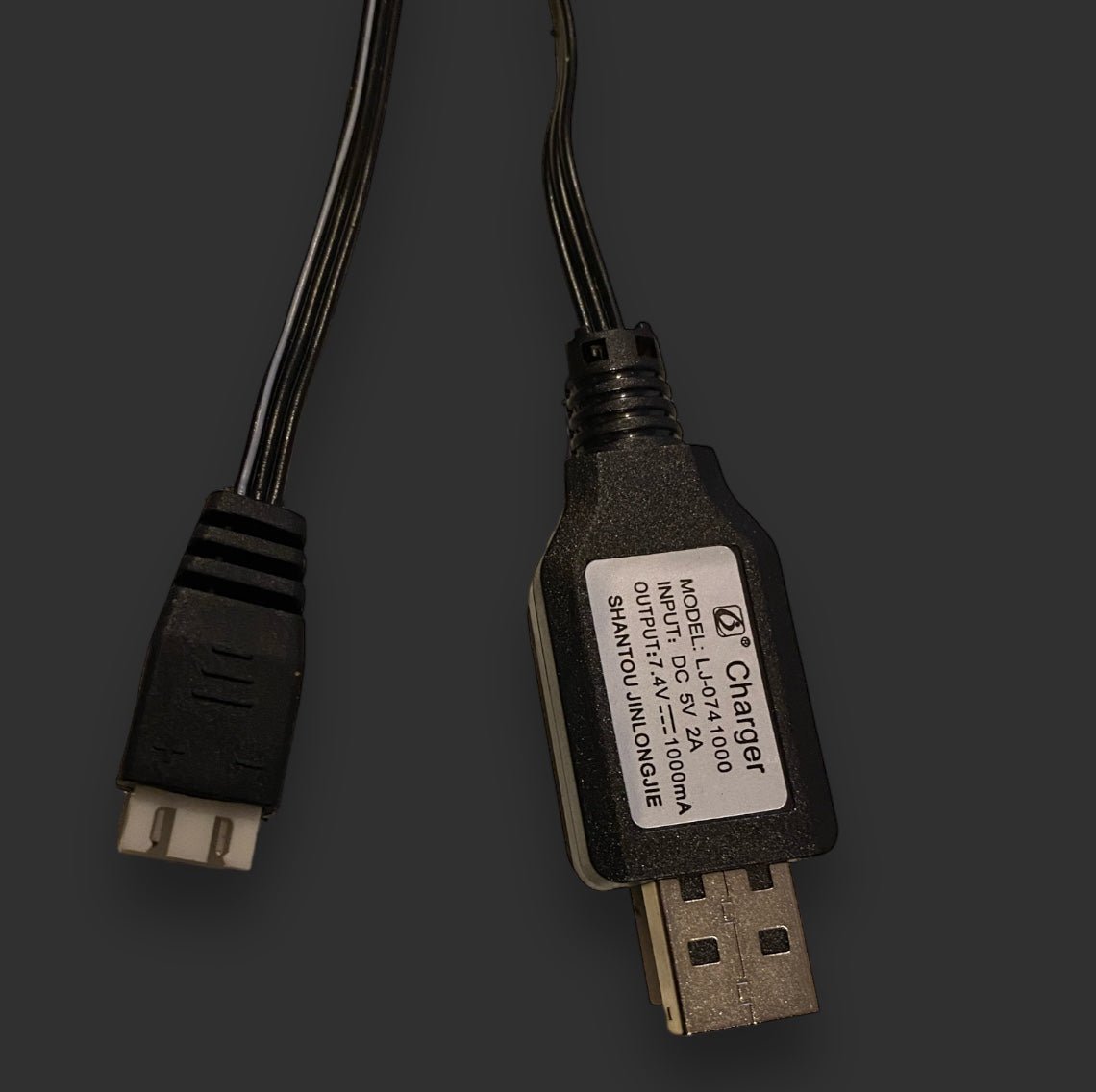 A BlasterMaster 7.4v 3P Li-ion usb battery charger with an attached label showing model LD-23I, input 5V-2A, output 5V-1000MA, manufactured in July 2016. Ideal for efficient charging of gel blasters and compatible with a 7.4V 3P Li-ion Battery Charger.