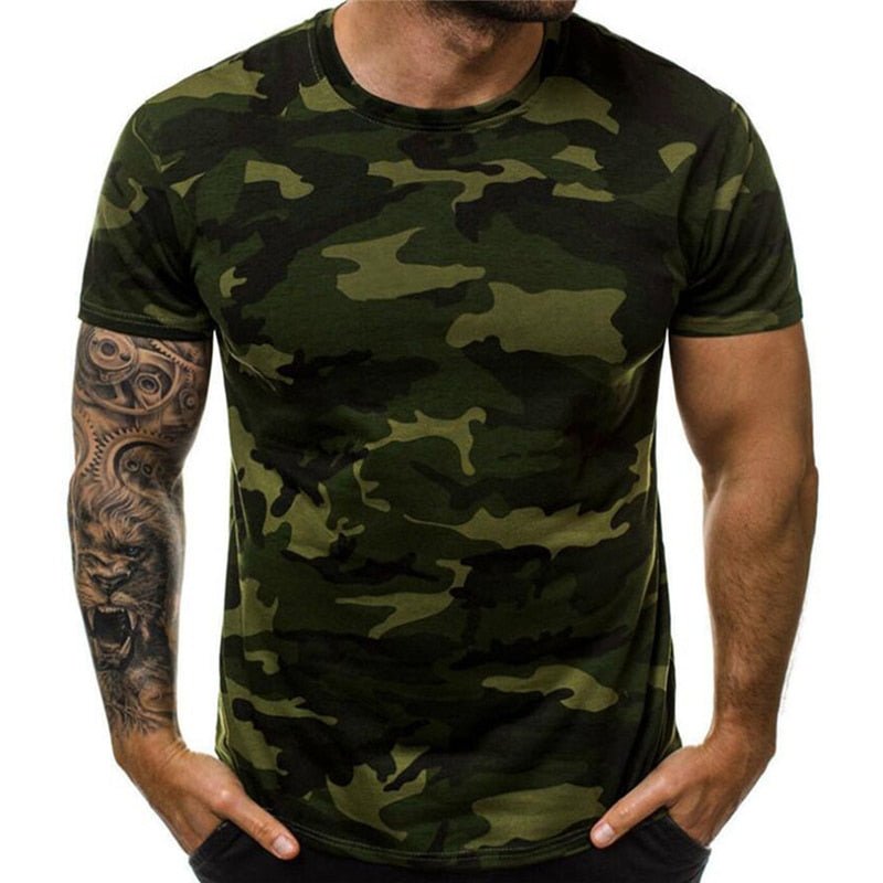 A person wearing a BlasterMaster Camo T-Shirt with hands in pockets, typical High Street Leisure style. Their right arm has a detailed tattoo.