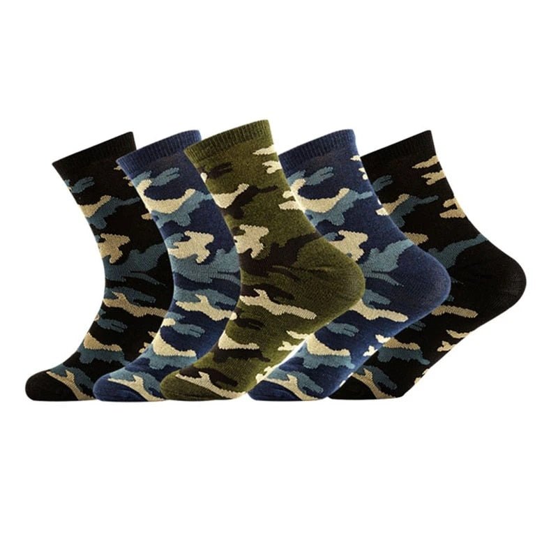 Five pairs of durable BlasterMaster Camo Socks in various camouflage patterns and colors, including green, blue, and black, arranged in a row.