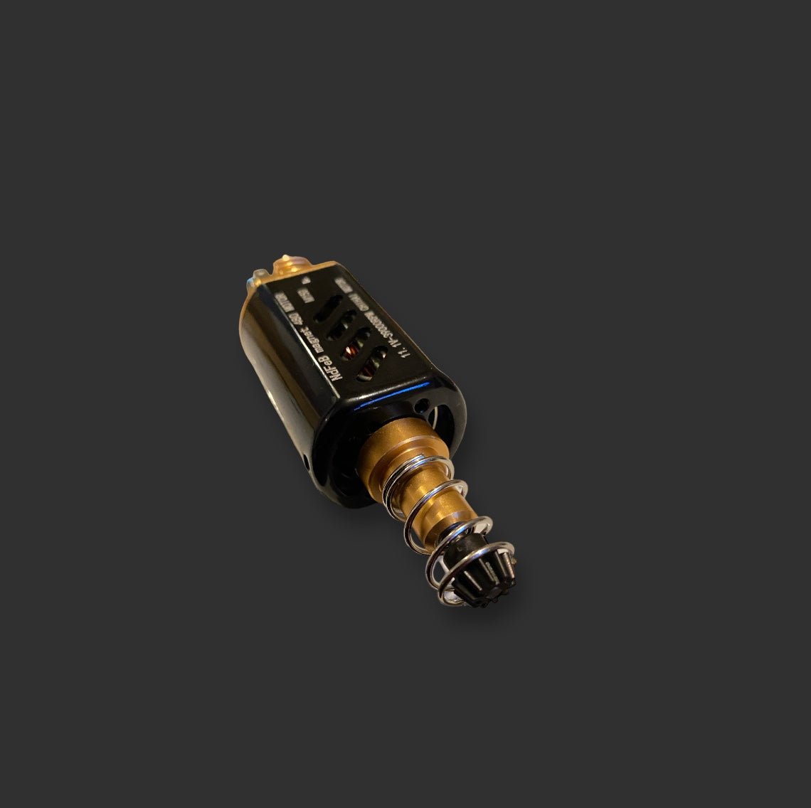 A black cylindrical electronic device with a gold and metal spring-like end, featuring a high-performance motor, laid on a dark background. This is the CHIHAI MOTOR 11.1V-39000RPM M150 by BlasterMasters.