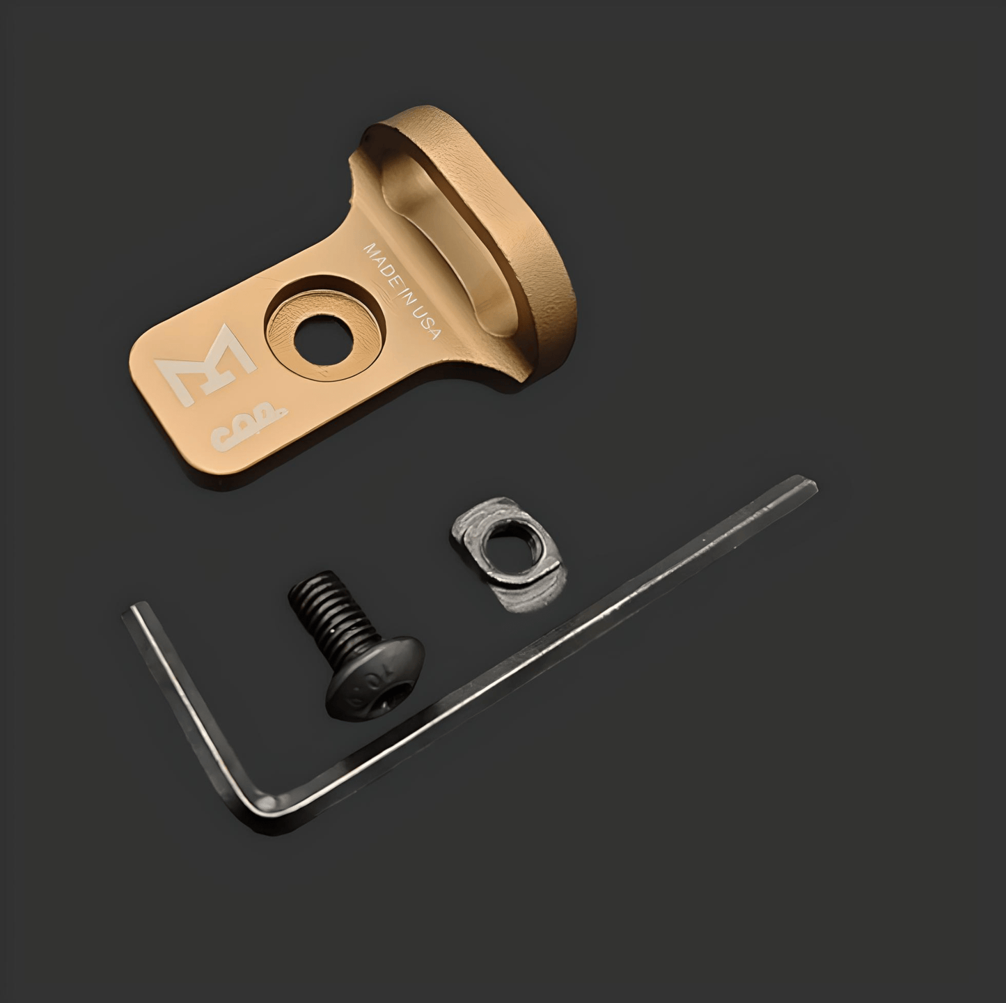 MLOCK CQD MLOK Forward Sling Mount including a gold-colored bracket labeled "MADE IN USA," a black screw, a metal nut, and an L-shaped hex key on a dark background. Designed for tactical performance and MLOK compatibility, this set ensures reliable use in demanding conditions.