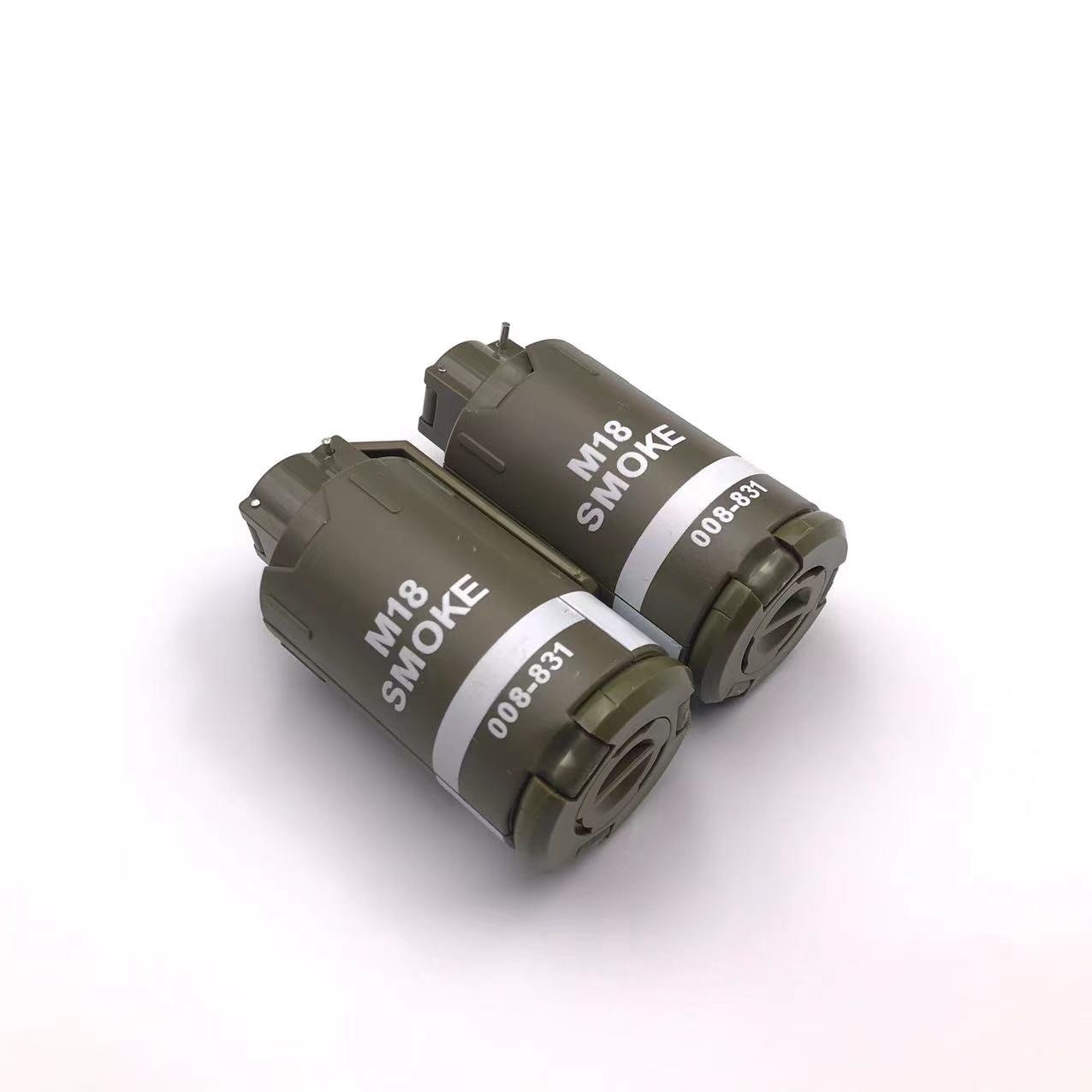 Two cylindrical G4 grenades by BlasterMaster with green outer casing and white labels are placed on a plain white background, ready to unleash chaos.