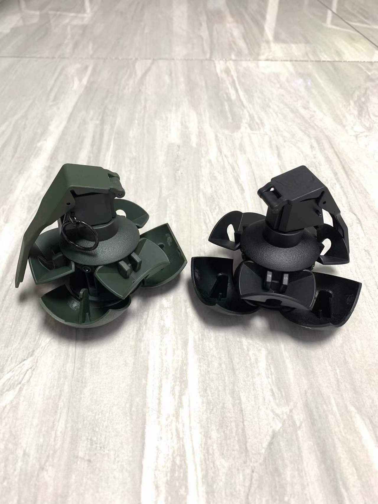 Two BlasterMaster G4 propeller systems are displayed on a light gray surface, featuring green and black color options, ready to unleash chaos on the water.