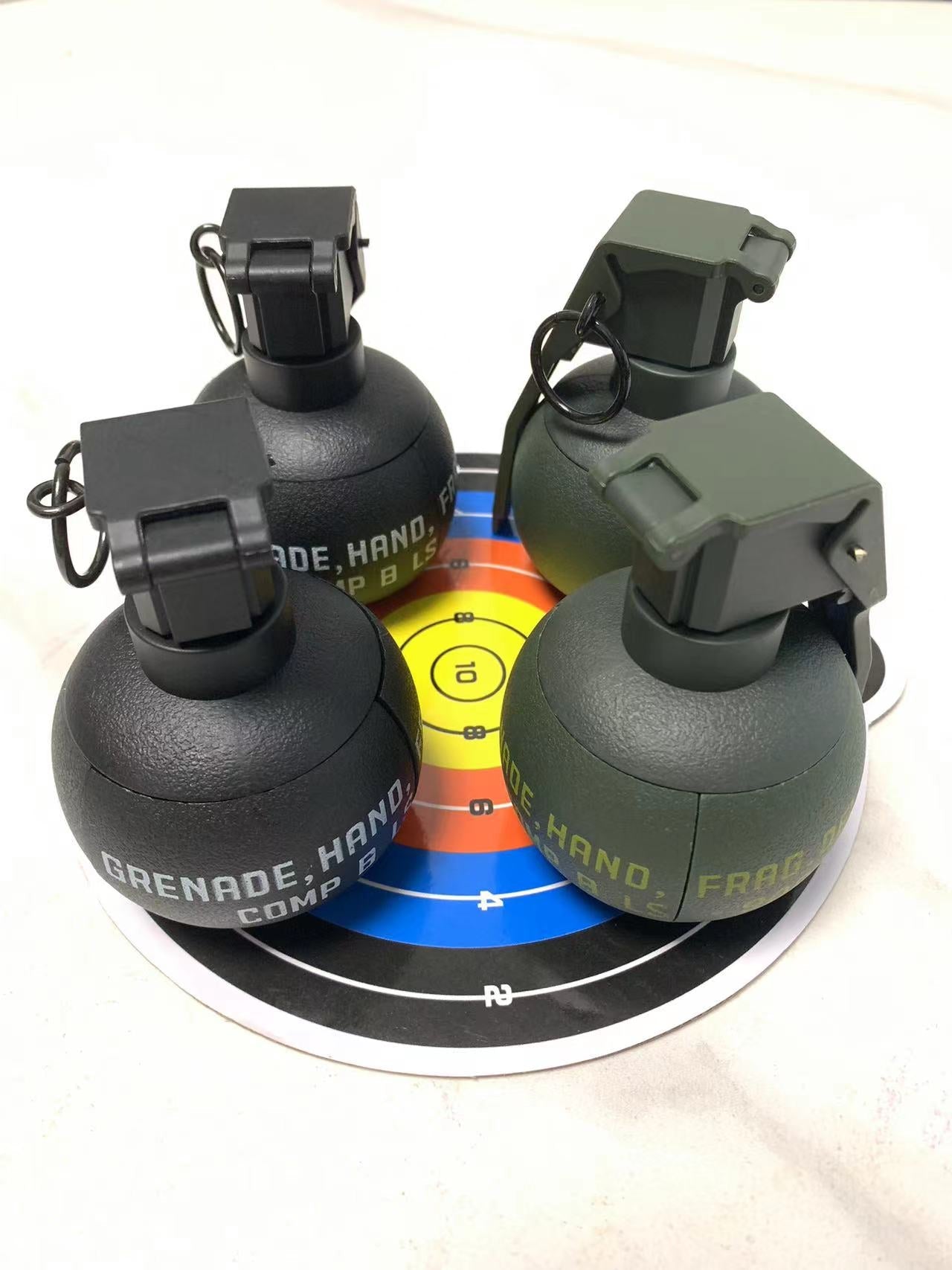 Three BlasterMaster G4s are positioned on a multicolored target sheet, with visible safety pins and a combination of black and green casings, ready to unleash chaos.