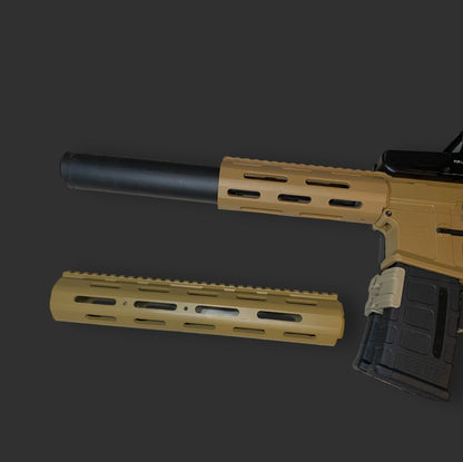 A disassembled rifle lying against a dark background, featuring a tan-colored body with a black suppressor and an additional tan-colored Honey Badger Handguard by BlasterMasters Upgrades placed beneath it, showcasing extensive personalization.