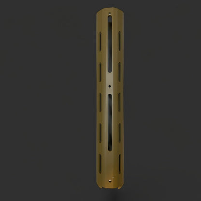 A cylindrical metal object with vertical slits and a single horizontal groove, colored in a matte gold finish, resembling the Honey badger Handguard by BlasterMasters Upgrades, on a dark background.