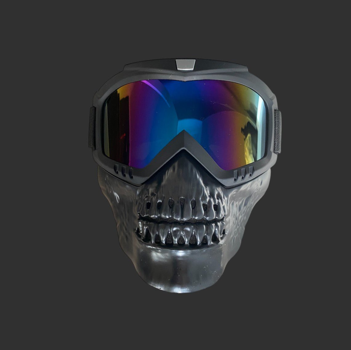 The Kids Gelsoft Mask by BlasterMasters is a black skull mask with reflective goggles, featuring a grinning skeletal face and colorful lenses. Its lightweight construction and adjustable design ensure both comfort and a secure fit, set against a plain dark background.