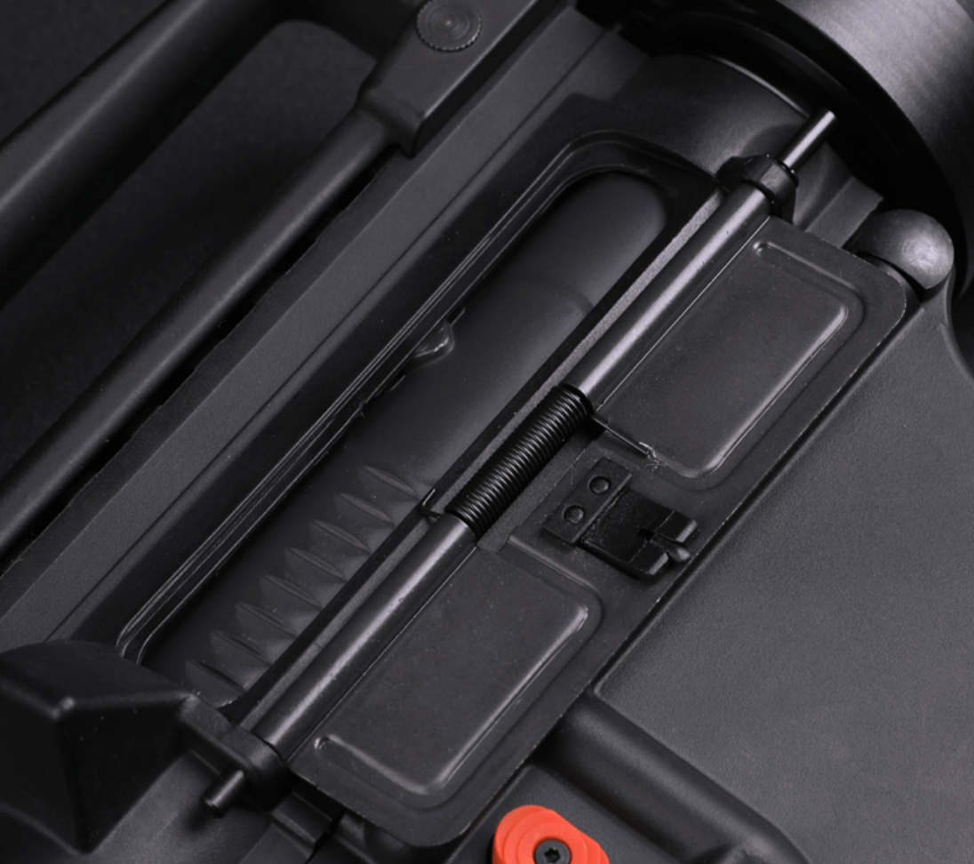 Close-up of a Kublai M4-Style Gel Blaster's bolt carrier group and ejection port, with the dust cover partially open, revealing internal components that showcase tactical engineering.