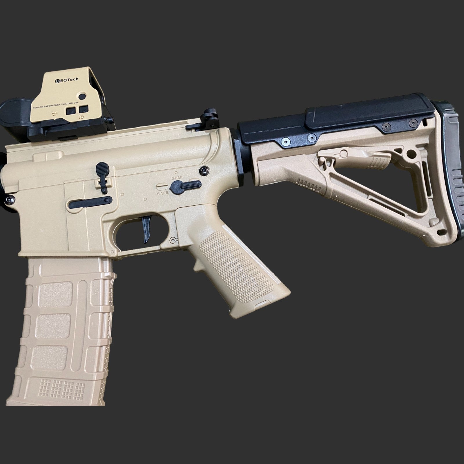 A tan-colored M4A1 Fully Loaded Tactical Operator rifle with a black adjustable stock, pistol grip, EOTech holographic sight, and a tan magazine, outfitted with tactical accessories ideal for any mission by Bohan.