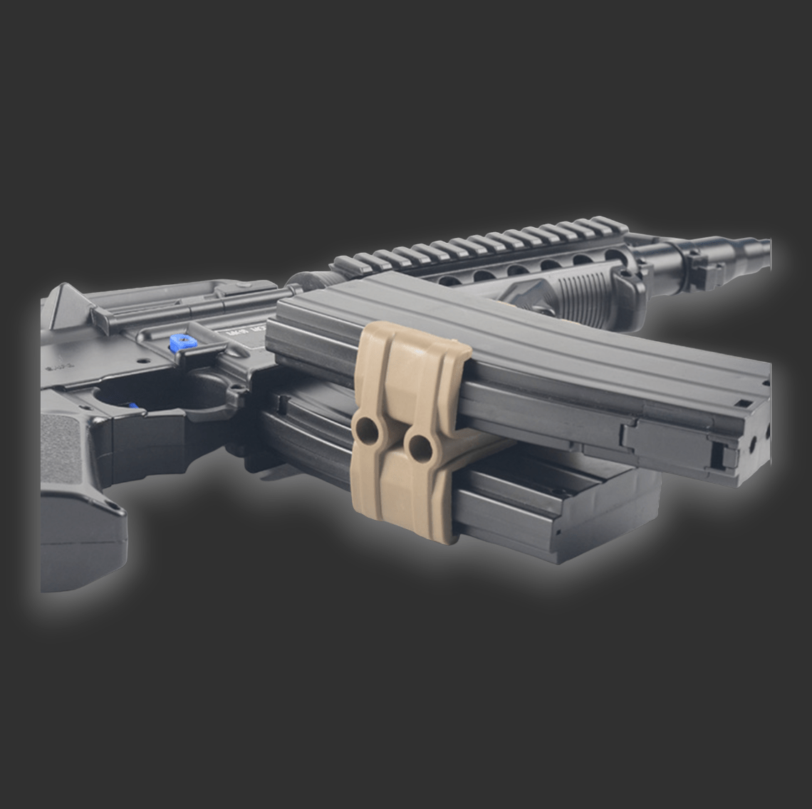 Close-up of a tactical firearm with dual magazines attached side-by-side using a BlasterMasters Dual magazine clip, showcasing its rapid reload capability against a dark background.