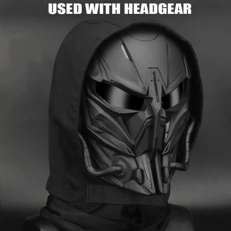 A black futuristic helmet with angular, robotic features and a dark hood covering the head, showcasing advanced protection and durable construction, accompanied by the text "USED WITH HEADGEAR" at the top. This PREDATOR MASKS by BlasterMaster offers both style and safety for any mission.