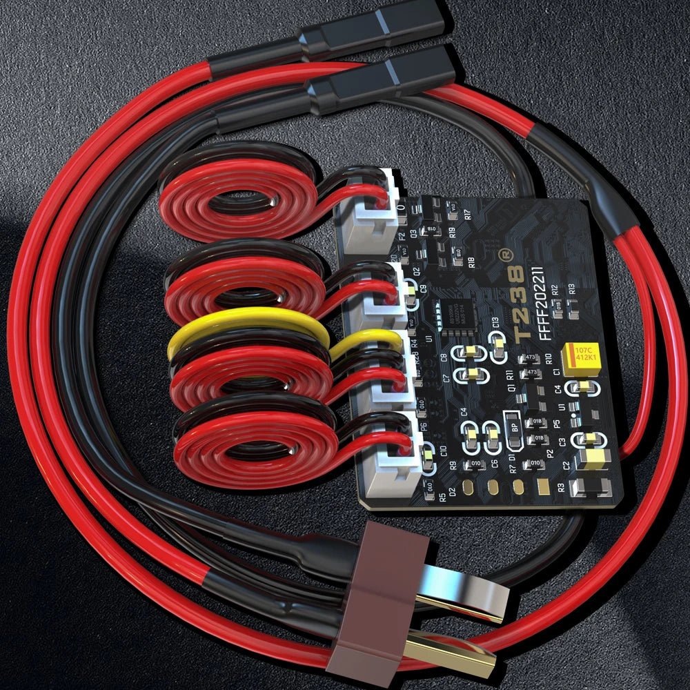 Close-up of an electronic circuit board connected to various red and black wires, coiled cables, and connectors featuring a BlasterMasters T238 Kriss MOSFET ETU Module with digital trigger and low battery voltage protection, placed on a dark surface.