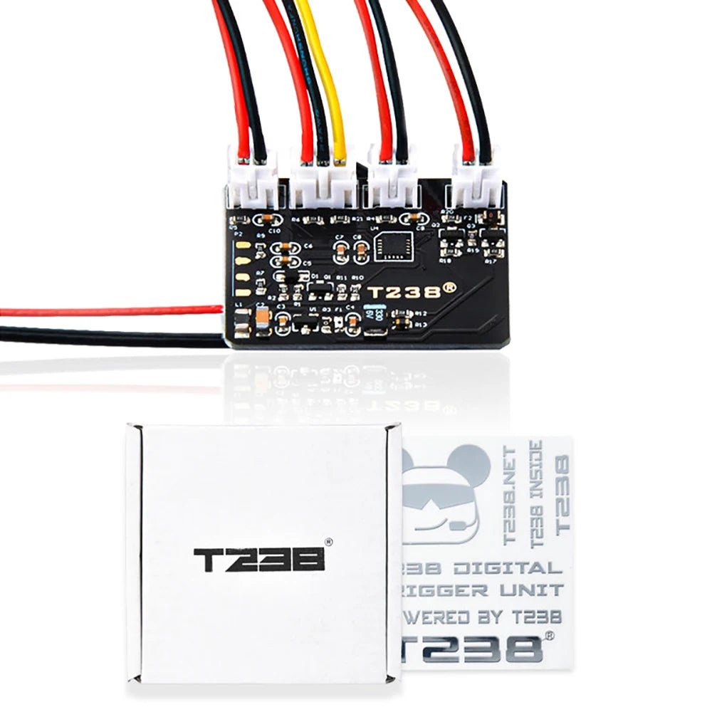 A small electronic circuit board with multiple colored wires attached. Below it are two white boxes, one of which reads "T238 Kriss MOSFET ETU Module," indicating advanced low battery voltage protection by BlasterMasters.