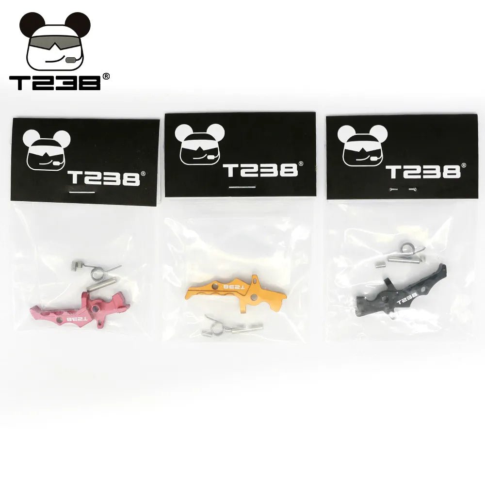 Three BlasterMasters branded T238 Trigger containing vibrant colored parts (red, yellow, black), small metal components, and a V2 Gearbox made from CNC aluminum alloy are displayed against a white background.