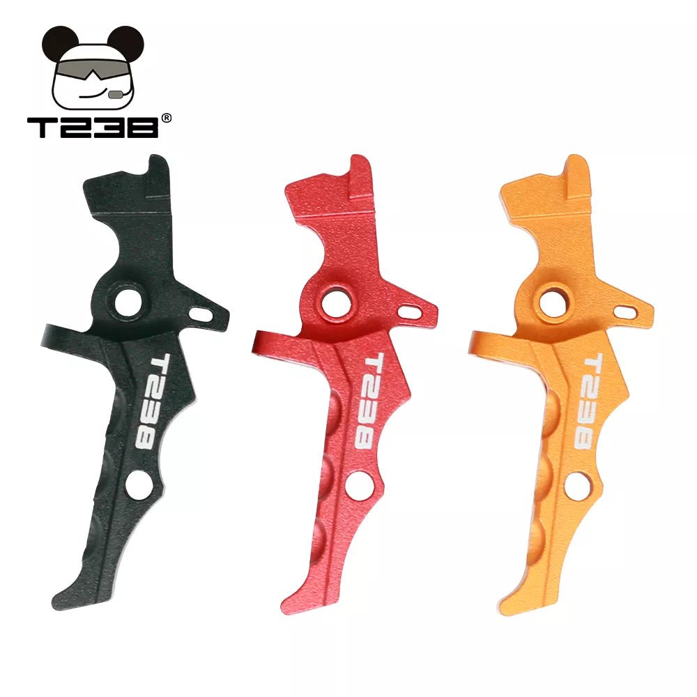 Three metallic T238 Triggers by BlasterMasters in black, red, and gold color are arranged vertically. Crafted from CNC aluminum alloy, these triggers are compatible with a V2 Gearbox. The T238 logo featuring a bear wearing sunglasses and headphones is present in the upper left corner.