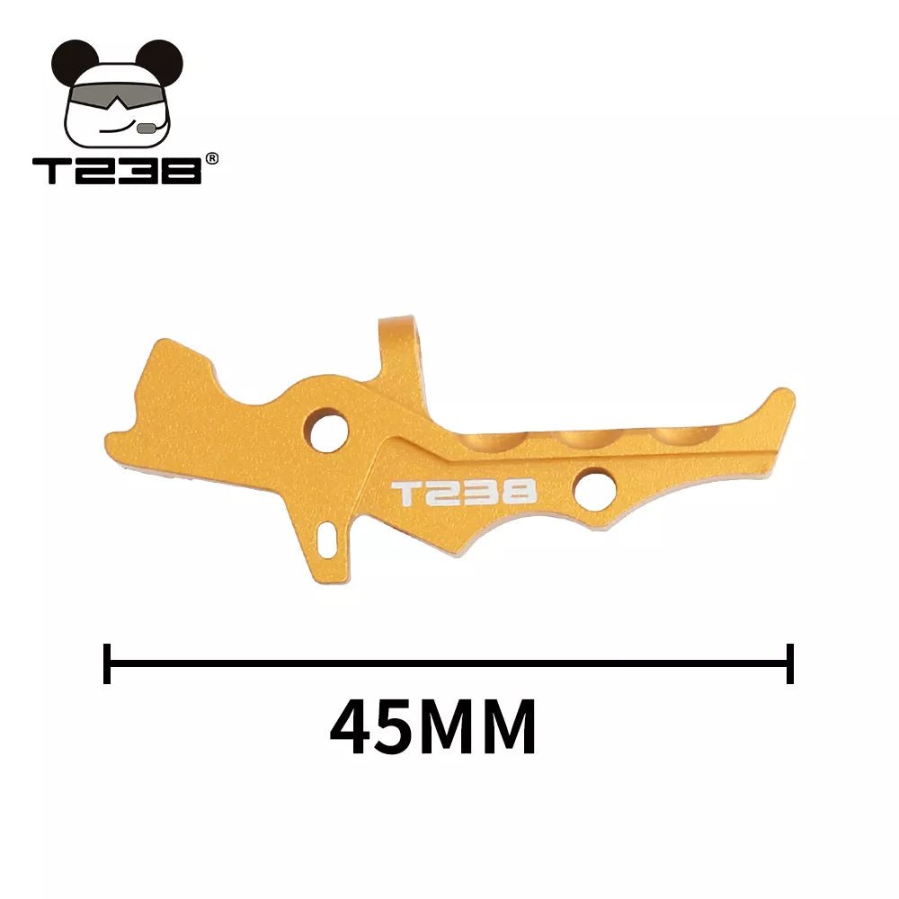 A gold BlasterMasters T238 Trigger with a length of 45mm, crafted from CNC aluminum alloy and featuring a unique design, placed against a white background.