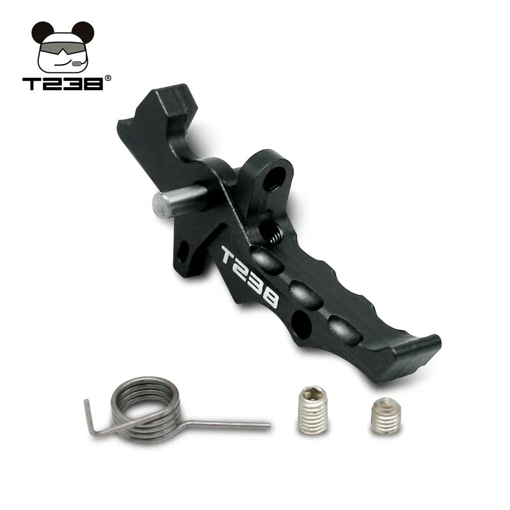 This black metal toy part, crafted from CNC aluminum alloy, features "T238 Trigger" text and includes three additional components: a spring and two small cylindrical pieces. It also boasts a logo of a cartoon character with glasses and headphones from BlasterMasters.