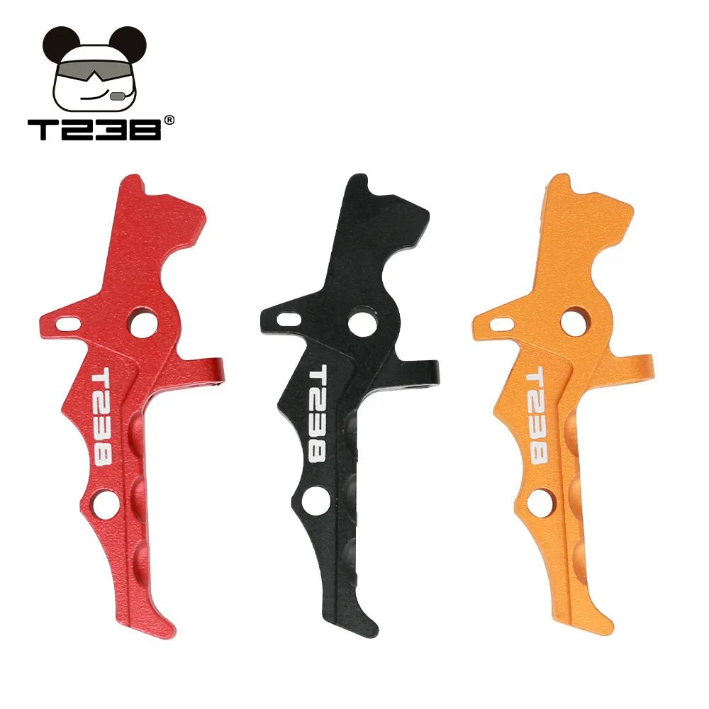 Three BlasterMasters T238 Trigger CNC aluminum alloy trigger levers in red, black, and orange against a white background, with a logo featuring a bear face and "T238" text at the top left corner. Designed for V2 Gearbox systems, these triggers merge precision with durability.