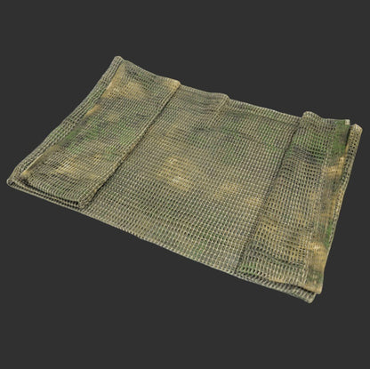 A folded camouflage mesh net against a dark background, this versatile tool doubles as a BlasterMasters Tactical Scarf for outdoor adventures or gel blaster games.